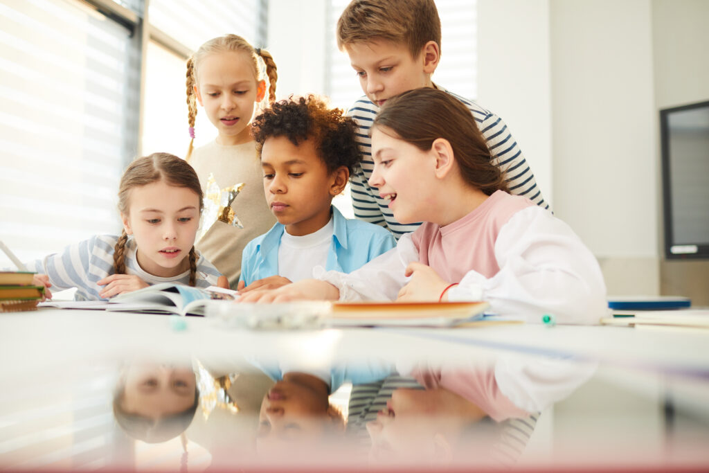 children looking through book illustrations