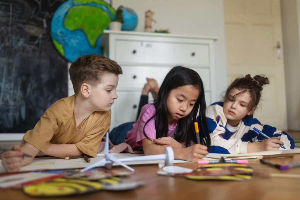 School-Based Learning Environments – Preparing Children for Real Classrooms happy friends working on school project together.